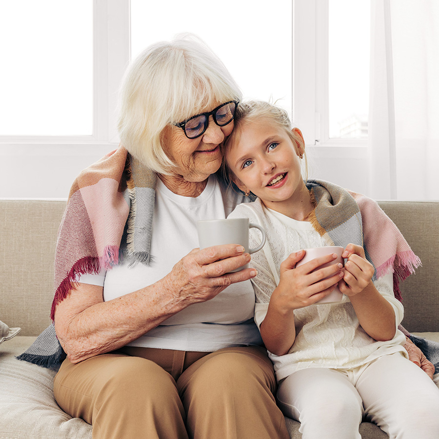 smiling girl and senior woman enjoying cups of tea 2026 01 08 07 09 26 utc
