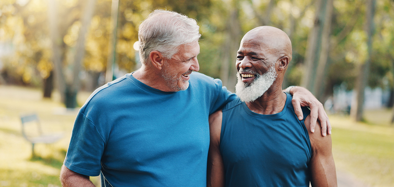 two men laughing together in the sunny park 2026 03 25 03 35 15 utc