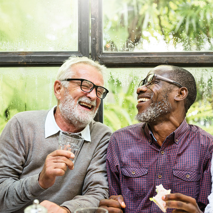 two senior men laughing together indoors at cafe 2026 01 07 23 36 26 utc