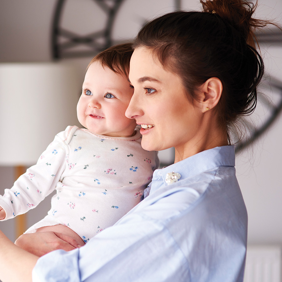 mother carrying her baby at home 2026 03 09 04 27 11 utc