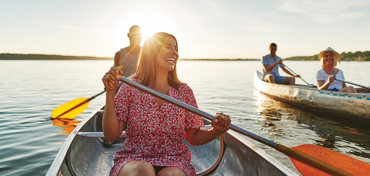 laughing woman canoeing with friends on a late sum 2022 02 02 04 52 21 utc