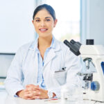 young woman scientist working with microscope 2026 03 25 08 26 37 utc